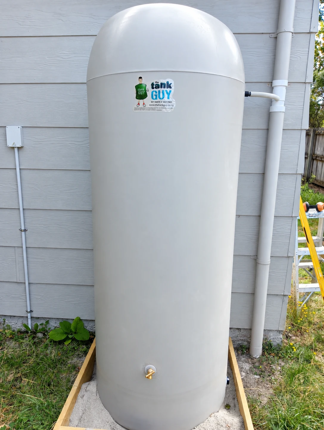 Slimline tank connected to a house downpipe