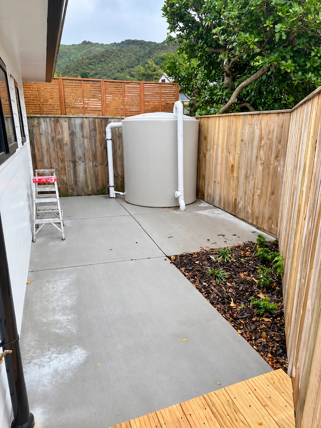 Water tank installed at the end of a paved courtyard