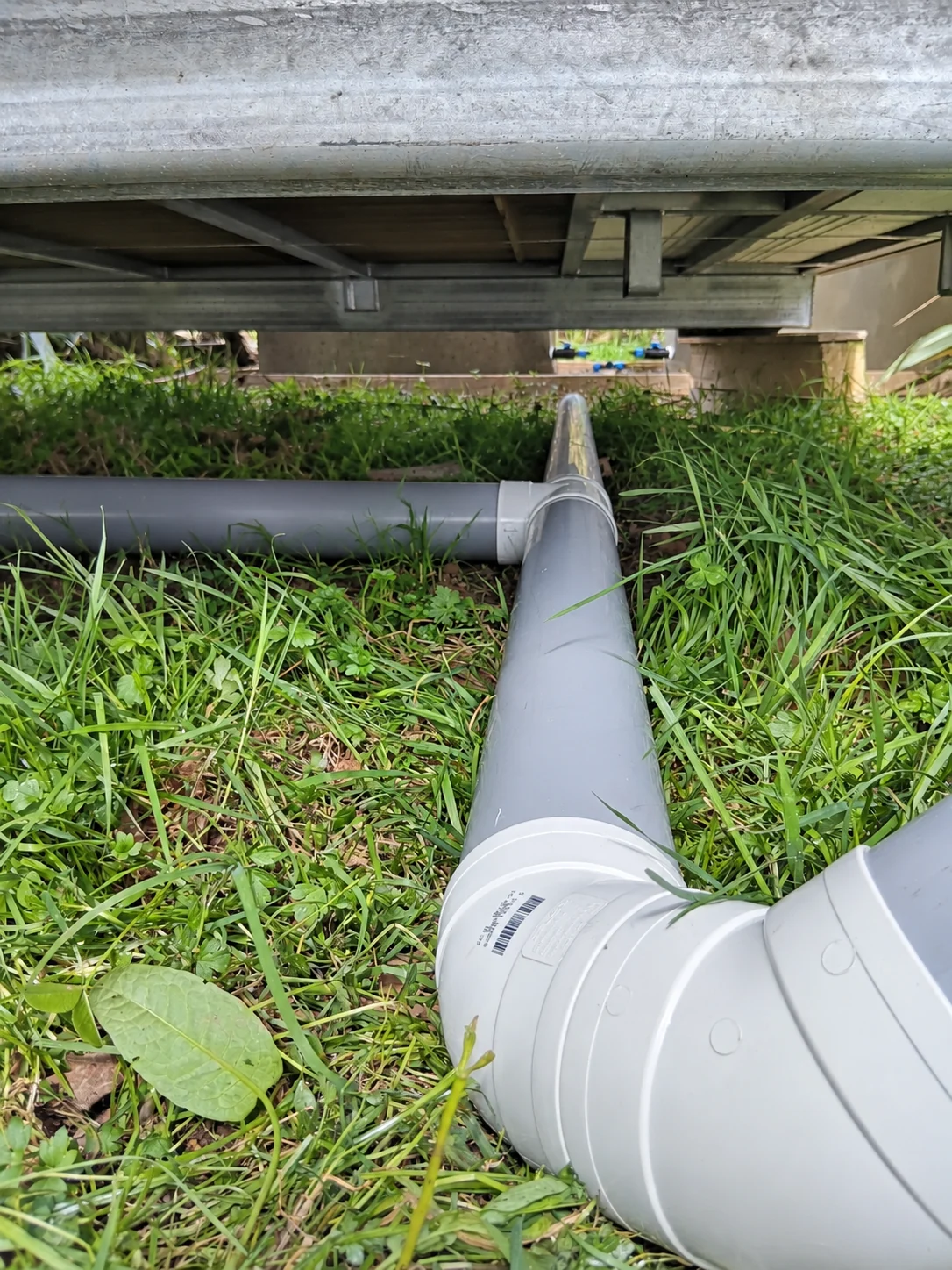 PVC pipework below a water tank installation